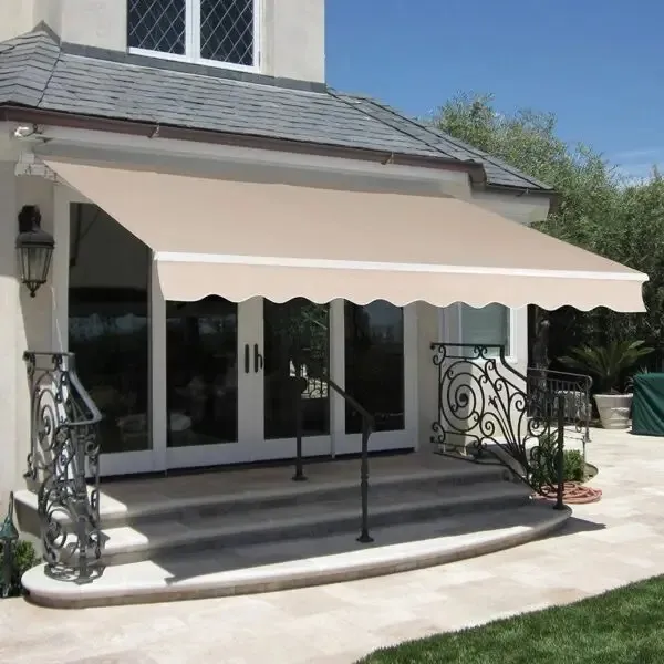 White building with a black awning over two windows