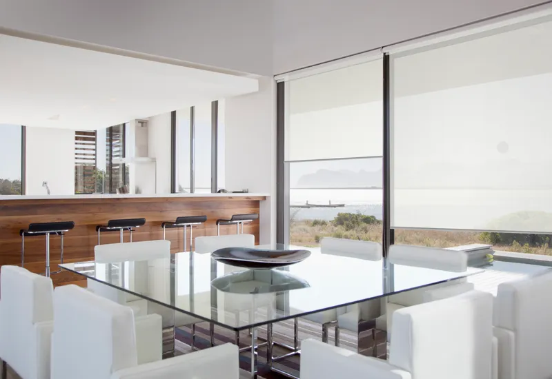 Inside a home with white shades on the windows