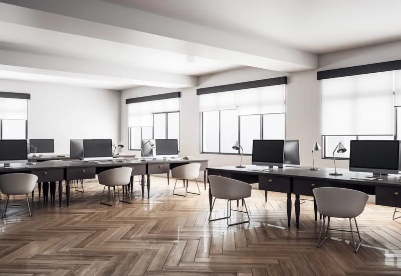 Inside an office room with white shades on the windows